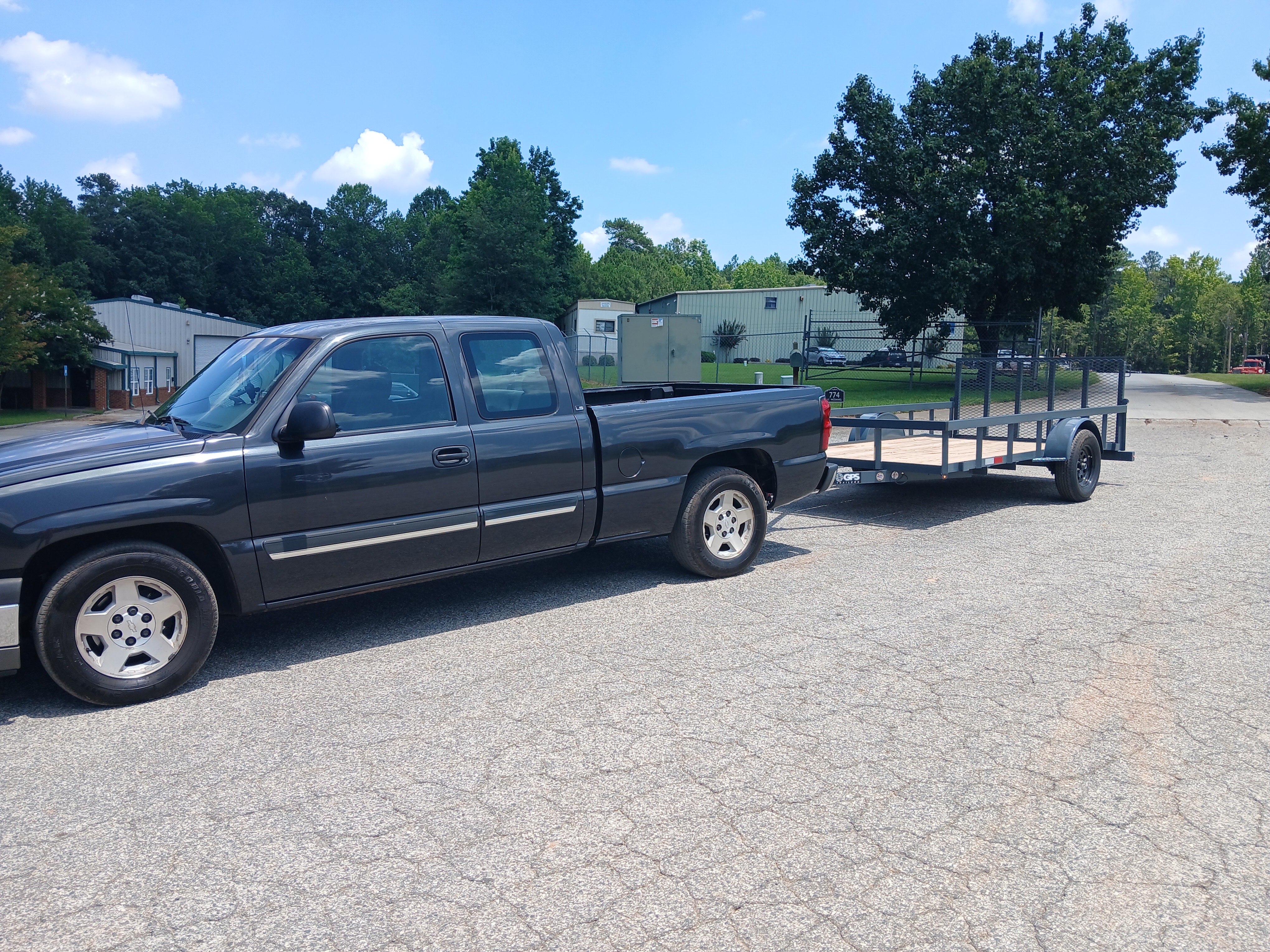D&S Junk Removal 12 ft dovetail utility rental trailer hitched to a pickup truck